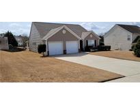 Inviting home showcasing a well-maintained lawn and a two-car garage at 4644 Pine Isle Way, Sugar Hill, GA 30518