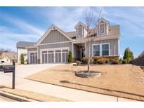 Beautiful craftsman-style home featuring a three-car garage and manicured front yard, offering great curb appeal at 505 Windy Ridge Ct, Canton, GA 30114