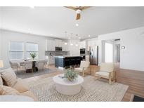 Bright, open-concept living space flows into a modern kitchen with a large island and stainless steel appliances at 505 Windy Ridge Ct, Canton, GA 30114