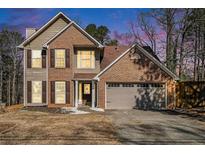 Two-story brick home with a two-car garage and well-maintained landscaping at 2095 Springer Walk, Lawrenceville, GA 30043