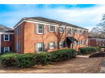 Charming brick apartment building featuring classic architectural details and manicured landscaping at 560 Goldsboro Ne Rd # C, Atlanta, GA 30307
