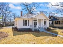 Charming renovated single-story home featuring fresh paint, manicured yard and inviting front porch at 34 N Broad N St, Porterdale, GA 30014