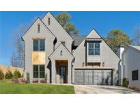 Stunning two-story gray brick home featuring a wood accent wall, two-car garage and manicured front lawn at 262 Green Hill Ne Rd, Sandy Springs, GA 30342