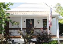 Charming front porch with hanging plants and black door, perfect for relaxing at 4040 Merritt Dr, Cumming, GA 30041