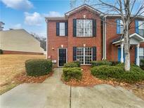 Charming brick home with well-maintained landscaping and a cozy front entrance, nestled under a bright blue sky at 3153 Kingswood Gln, Decatur, GA 30034