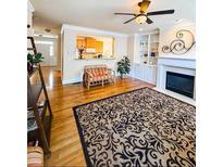 Cozy living room boasts hardwood floors, a fireplace, and large decorative rug at 2371 Bellefonte Ave # 61, Lawrenceville, GA 30043