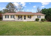 Charming single-story home with a well-manicured lawn and inviting front porch at 140 Wyonia Way, Fayetteville, GA 30215