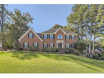 Stately brick two-story home with manicured lawn and mature trees, offering classic curb appeal at 4742 Balmoral Ne Way, Marietta, GA 30068