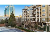 Attractive condominium building with multiple balconies and views of the city skyline at 799 Hammond Dr # 219, Atlanta, GA 30328