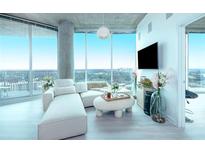 Bright living room with floor-to-ceiling windows showcasing a stunning city view, and white contemporary furniture at 361 17Th St # 2122, Atlanta, GA 30363