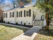 Charming, newly renovated one-story white brick home with black shutters and front yard at 1764 Springview Nw Rd, Atlanta, GA 30314