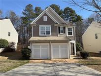 Charming two-story home with a two-car garage and neutral-toned siding at 2643 Winslow Ridge Dr, Buford, GA 30519