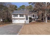 Charming two-story home with a well-manicured lawn, attached two car garage, and classic architectural details at 70 Nw Willow Bend Dr, Cartersville, GA 30121