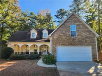 Charming two-story home with a stone facade and attached two car garage at 959 Gettysburg Way, Locust Grove, GA 30248