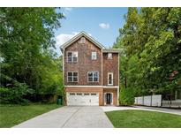 Charming two-story home with shingle and brick facade, complemented by a well-manicured lawn and ample driveway at 1303 N Druid Hills Ne Rd, Brookhaven, GA 30319