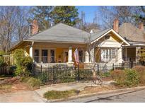 Charming yellow home with a welcoming front porch and neat landscaping at 404 Oakdale Ne Rd, Atlanta, GA 30307
