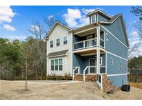 Charming two-story home with blue siding, white trim, and a welcoming covered porch at 3139 Stonegate Sw Dr, Atlanta, GA 30331