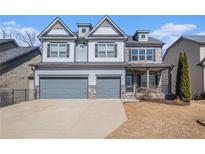 Charming two-story home with a two-car garage and a well-maintained front yard at 4525 Hopewell Manor Dr, Cumming, GA 30028