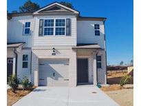 Two-story home with brick accents, featuring a one-car garage and well-maintained landscaping at 2284 Jamin Bnd # 18, Lithonia, GA 30058