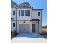Charming townhome featuring a one-car garage, neutral paint scheme, and a welcoming front entrance at 2284 Jamin Bnd # 18, Lithonia, GA 30058