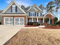 Charming two-story home with brick accents, a manicured lawn, and a two car garage at 625 Willow Pointe Dr, Dallas, GA 30157