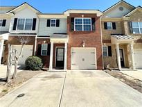 Charming brick townhouse with a one-car garage and a welcoming front entrance and driveway at 2795 Greenbridge Drive, Norcross, GA 30071