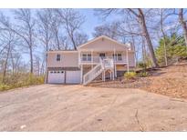 Charming split-level home with a two-car garage and inviting front porch at 322 Corley Cir, Hiram, GA 30141