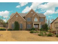 Charming brick two-story home featuring manicured landscaping and a welcoming front entrance at 2180 Hilltop Overlook Way, Marietta, GA 30062