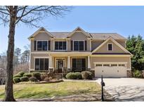 Charming two-story home featuring a manicured front yard and a two-car garage at 4012 Grand Park Ne Dr, Suwanee, GA 30024