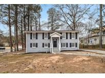 Charming two-story home features black shutters and a well-manicured front yard at 5257 Orly Ter, Atlanta, GA 30349