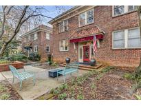 Charming brick apartment building entrance with manicured landscaping and inviting outdoor seating at 1111 Briarcliff Ne Pl # 2, Atlanta, GA 30306