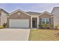 Charming one-story brick home with a two-car garage and a well-maintained front yard at 1991 Vidalia Ct, Dacula, GA 30019