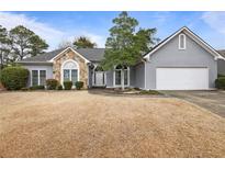 Charming single-story home with stone accents, attached garage, and well-maintained lawn at 1099 Wynford Cmns, Marietta, GA 30064