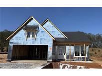 New construction home featuring an attached garage, covered entry, and a mix of window styles under a clear sky at 33 Cambridge Ln, Dallas, GA 30157