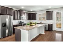 Modern kitchen features granite countertops, stainless steel appliances, and dark wood cabinetry at 4358 White Spruce Aly, Doraville, GA 30360