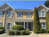 Charming townhome featuring stone accents, well-maintained landscaping, and inviting front entrance at 585 Mcwilliams Se Rd # 2602, Atlanta, GA 30315