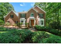 Beautiful brick home with manicured landscaping and a charming entrance nestled in a lush, green setting at 5960 Camelia Dr, Douglasville, GA 30135