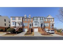 Charming townhome exteriors showcase brick accents, individual garages, and inviting entrances at 113 Brianna Way, Woodstock, GA 30188