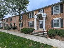 Charming brick home with a welcoming entrance, complemented by lush greenery and well-maintained landscaping at 6700 Roswell Rd # 24E, Atlanta, GA 30328