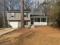 Charming two-story home featuring a front porch and attached garage at 885 Hemingway Rd, Stone Mountain, GA 30088