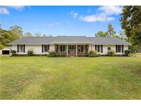Charming single-story home with a well-manicured lawn and inviting front porch at 273 Ralston Rd, Powder Springs, GA 30127