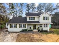 Charming two-story home featuring a cozy front porch and well-maintained landscaping at 2583 Bronco Trl, Duluth, GA 30096