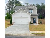 Charming two-story home featuring a two-car garage and manicured lawn at 203 Groveton Ct, Euharlee, GA 30145