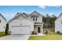 Charming two-story home with a two-car garage and a well-manicured front lawn at 203 Groveton Ct, Euharlee, GA 30145