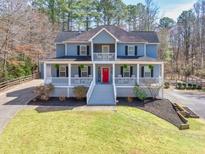 Stunning aerial view of a two-story home with a large yard and inviting front porch at 3564 Suwanee Creek Rd, Suwanee, GA 30024