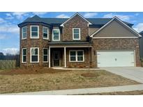Beautiful two-story brick home featuring a two-car garage and charming front porch at 117 Longhorn Way, Auburn, GA 30102
