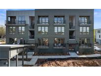 Modern townhome with multiple floors, balconies, and gray brick facade with black windows at 962 Bibbs Circle # 5, Atlanta, GA 30318