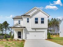 Charming two-story home featuring a white exterior, a two-car garage and a well manicured lawn at 204 Groveton Ct, Euharlee, GA 30145