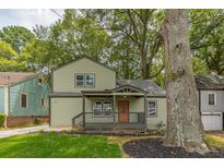 Charming two-story home featuring a covered front porch and well-manicured lawn at 1748 Alvarado Sw Ter, Atlanta, GA 30310