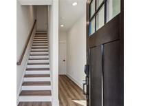 Inviting entryway featuring wood-look flooring, a staircase, and a door with glass inserts at 310 Mcdonough Se Blvd # 101, Atlanta, GA 30315